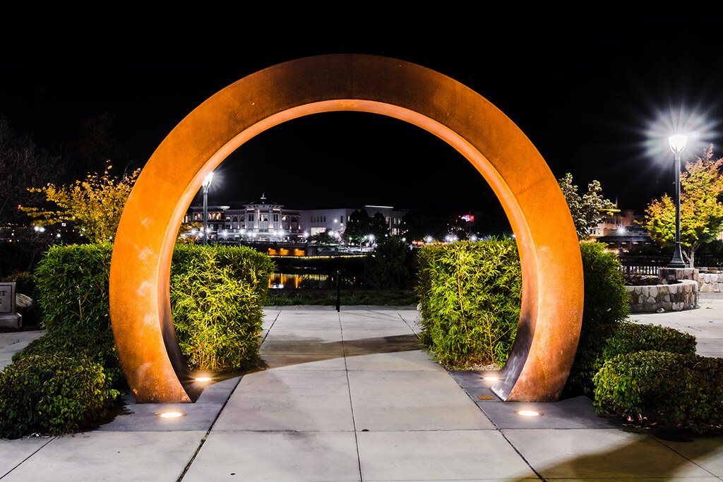 A large orange archway is lit up at night